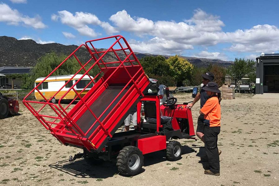 1 man by a pickman PICCA electric work platform and tipper with new zealand hills in background